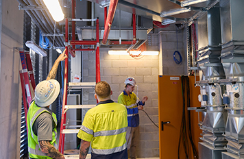 Three technicians coordinating a Comms cabling WA project through site surveys, installation, testing, documentation and handover.
