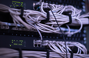Organised server rack with structured network cables supporting reliable communications infrastructure and Comms cabling WA.
